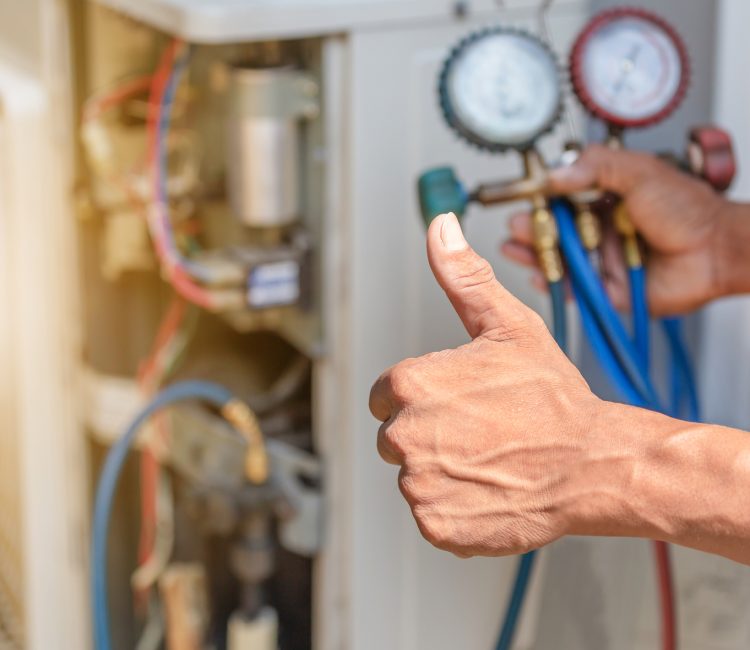 Close up of Air Conditioning Repair, repairman on the floor fixing air conditioning system