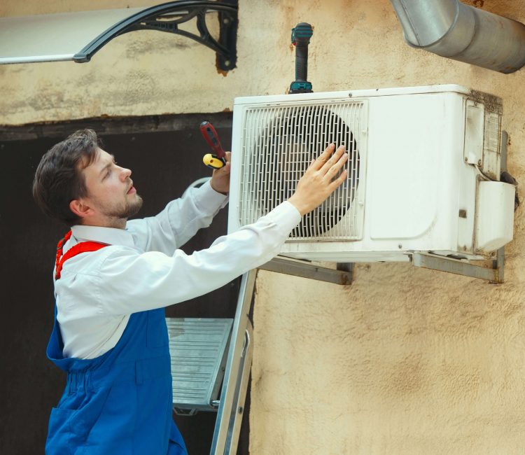 hvac_technician_working_capacitor_part_condensing_unit_male_worker-min (1)